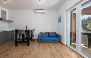 Enjoy a compact living space with a kitchenette, dining area, and comfortable seating area with a sofa.