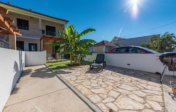 Enjoy an outdoor space with a patio, barbecue grill, and banana tree.