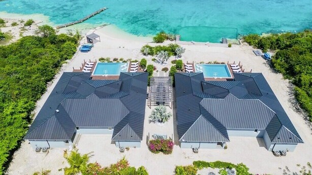 A resort with two large buildings, a pool area, and a beach. - Private Beachfront Luxury Villas with Dock & Heated Pools – Perfect for 10 Guests (Exuma)