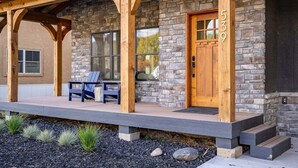 A stone house with a porch, a wooden door, and a bench. - Downtown Location, Walk to Town, Close to River, AC (Pagosa Springs)