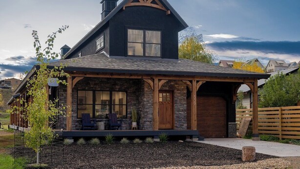 A modern house with a stone facade, large windows, and a covered porch. - Downtown Location, Walk to Town, Close to River, AC (Pagosa Springs)