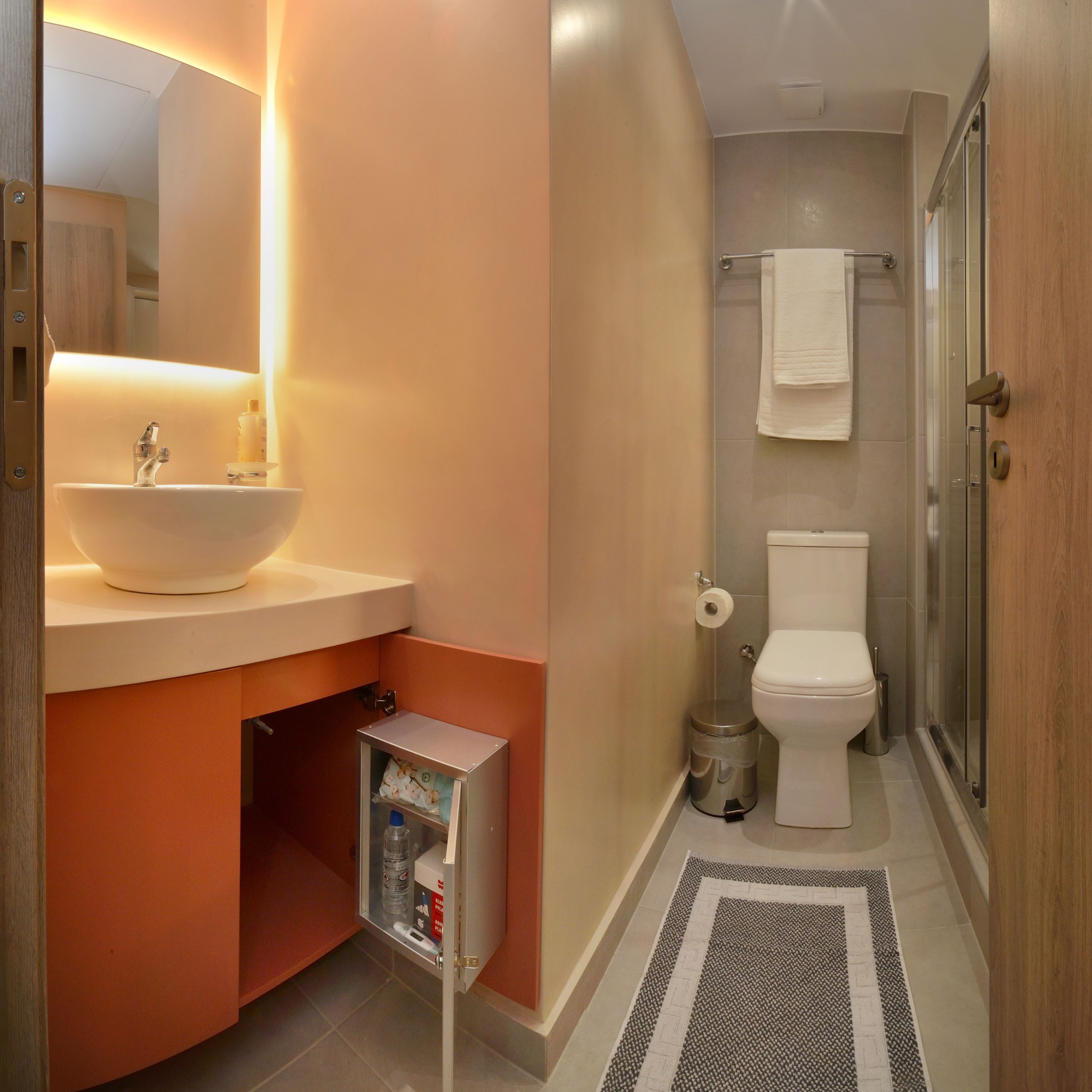 A bathroom with a sink, toilet, and shower.