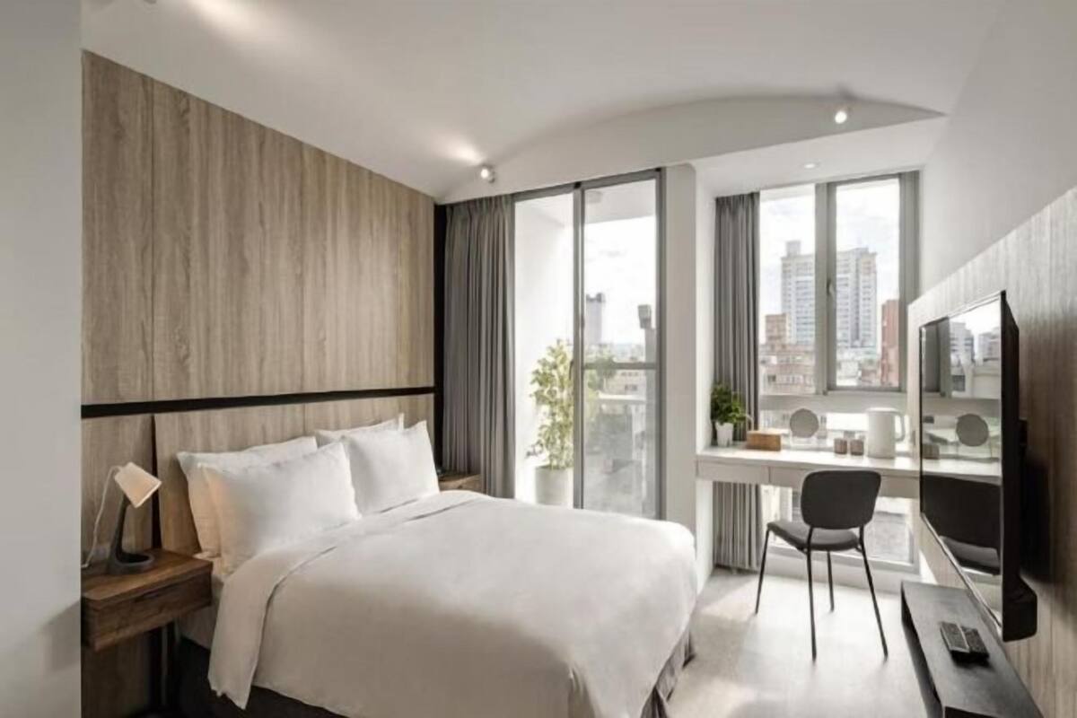 Premium bedding, desk, laptop workspace, blackout curtains