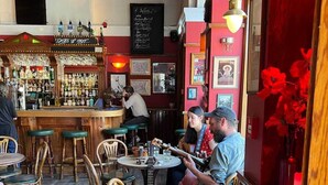 Un coin bar accueillant, avec des meubles en bois et une variété de bouteilles exposées sur des étagères.