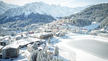 A snow-covered mountain town with buildings and a ski resort.