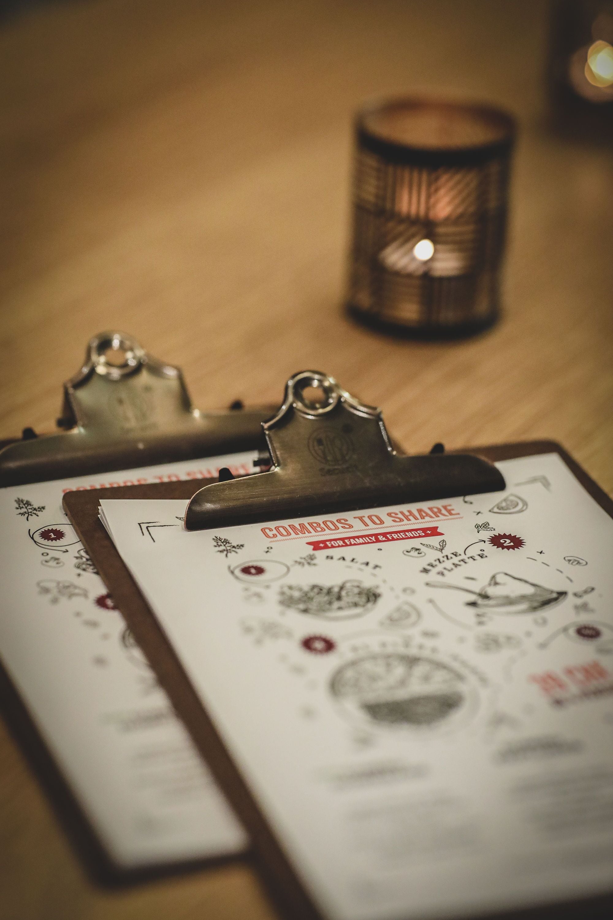 A clipboard with a document titled "Combos to Share" on a wooden surface.