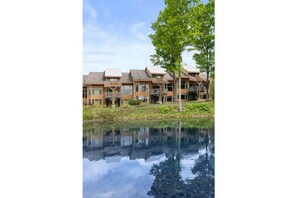 Stunning waterfront buildings with balconies and expansive windows.