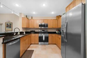 Enjoy cooking in this fully equipped kitchen with a refrigerator, microwave, and double oven.