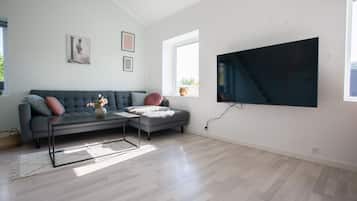 Executive Apartment | Living area | 50-inch Smart TV with digital channels, TV, heated floors