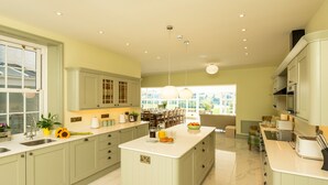 A spacious kitchen with a large island, ample counter space, and a view to the dining area.
