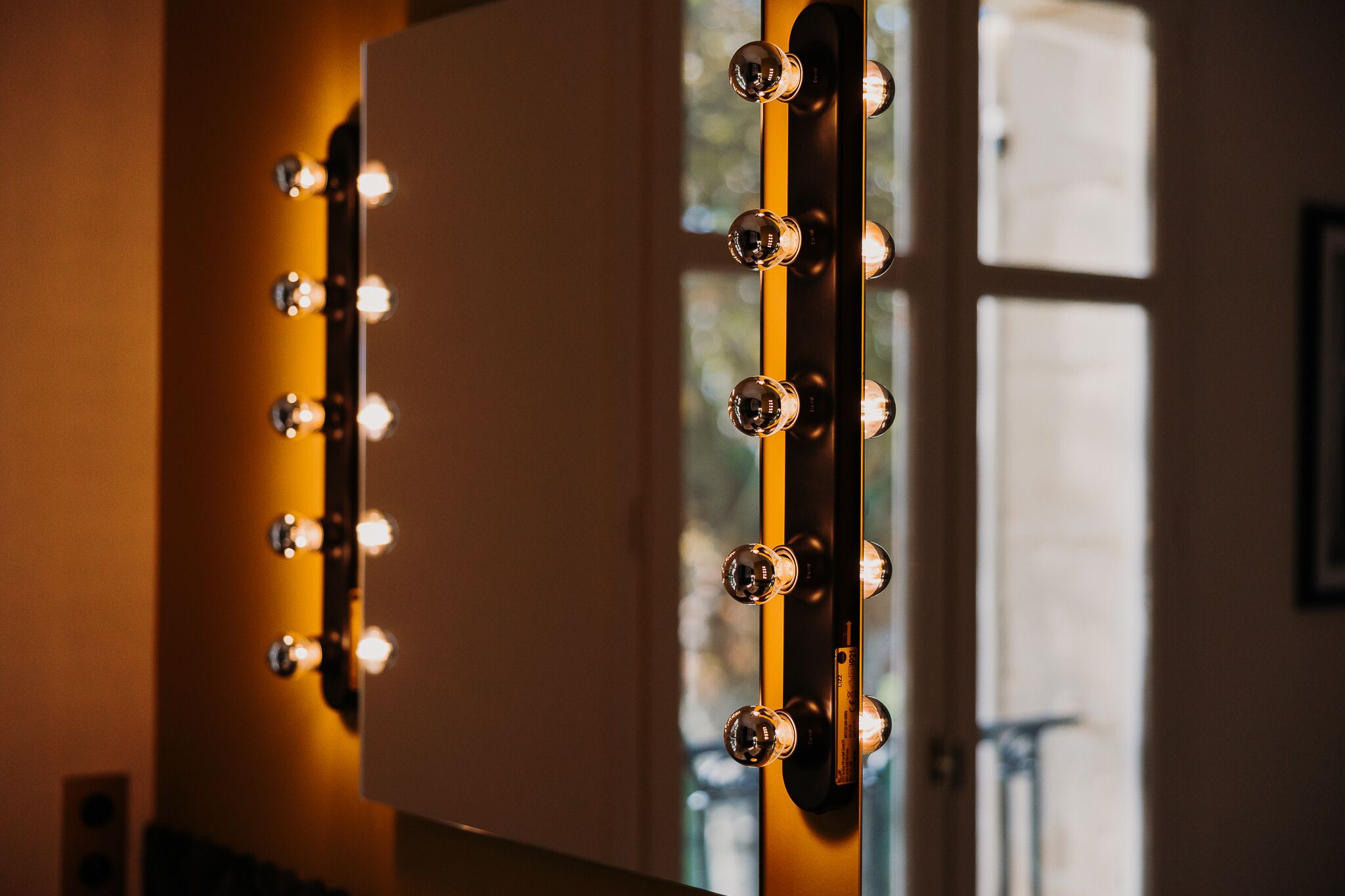 A mirror with lights around its edge, likely for a dressing room.