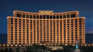 A large, multi-story hotel with a prominent marquee sign at the top. - Summer Vacay! 3Bed&3Bath-Walk 2 Beach, On-Site Pool, Golf, Casinos, Gated! (Gulfport)