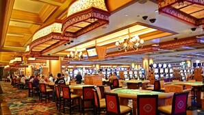 A casino with multiple gaming tables and chairs, a patterned carpet, and ornate ceiling decorations. - Summer Vacay! 3Bed&3Bath-Walk 2 Beach, On-Site Pool, Golf, Casinos, Gated! (Gulfport)