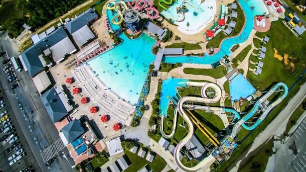 An aerial view of a water park with multiple slides and pools. - Summer Vacay! 3Bed&3Bath-Walk 2 Beach, On-Site Pool, Golf, Casinos, Gated! (Gulfport)