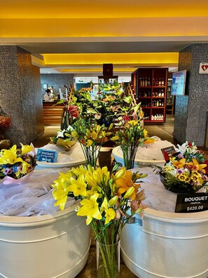 Fresh flowers and arrangements are on display, available for purchase.