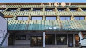 A building with a unique geometric facade and a sign reading "Moon Palace." - Moon Palace Hotel  (Arese)