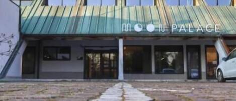 A building with a unique geometric facade and a sign reading "Moon Palace."