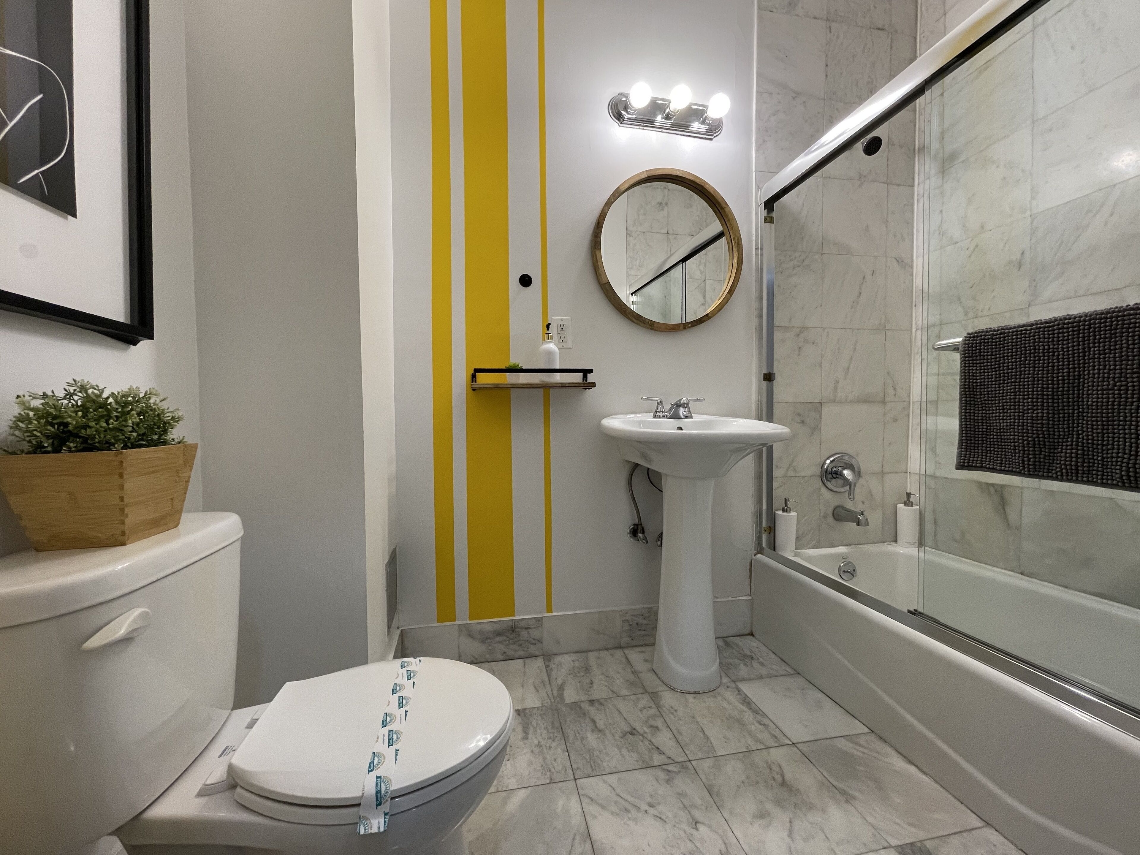 A modern bathroom with a toilet, sink, and bathtub.