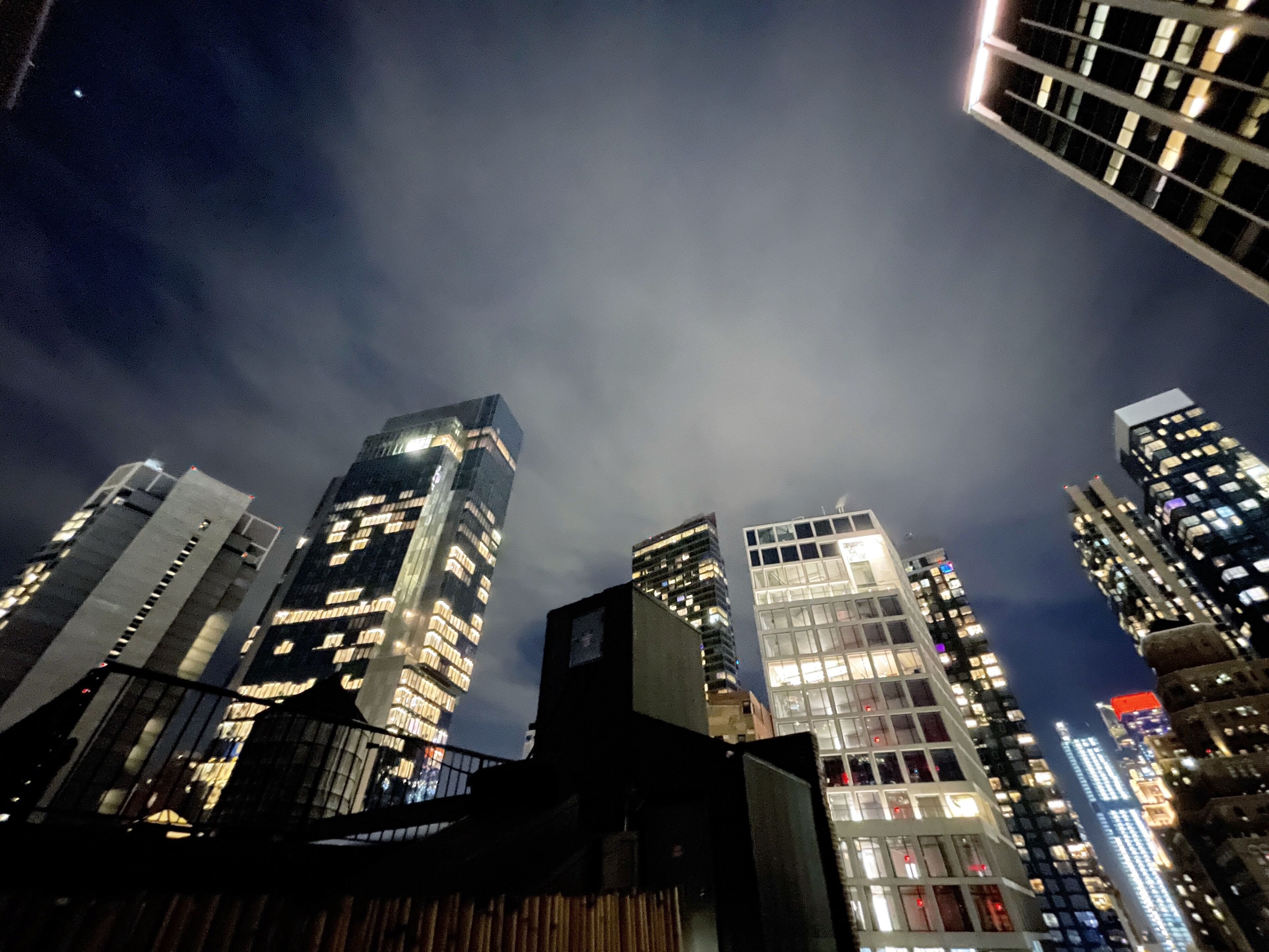 A nighttime cityscape with high-rise buildings.