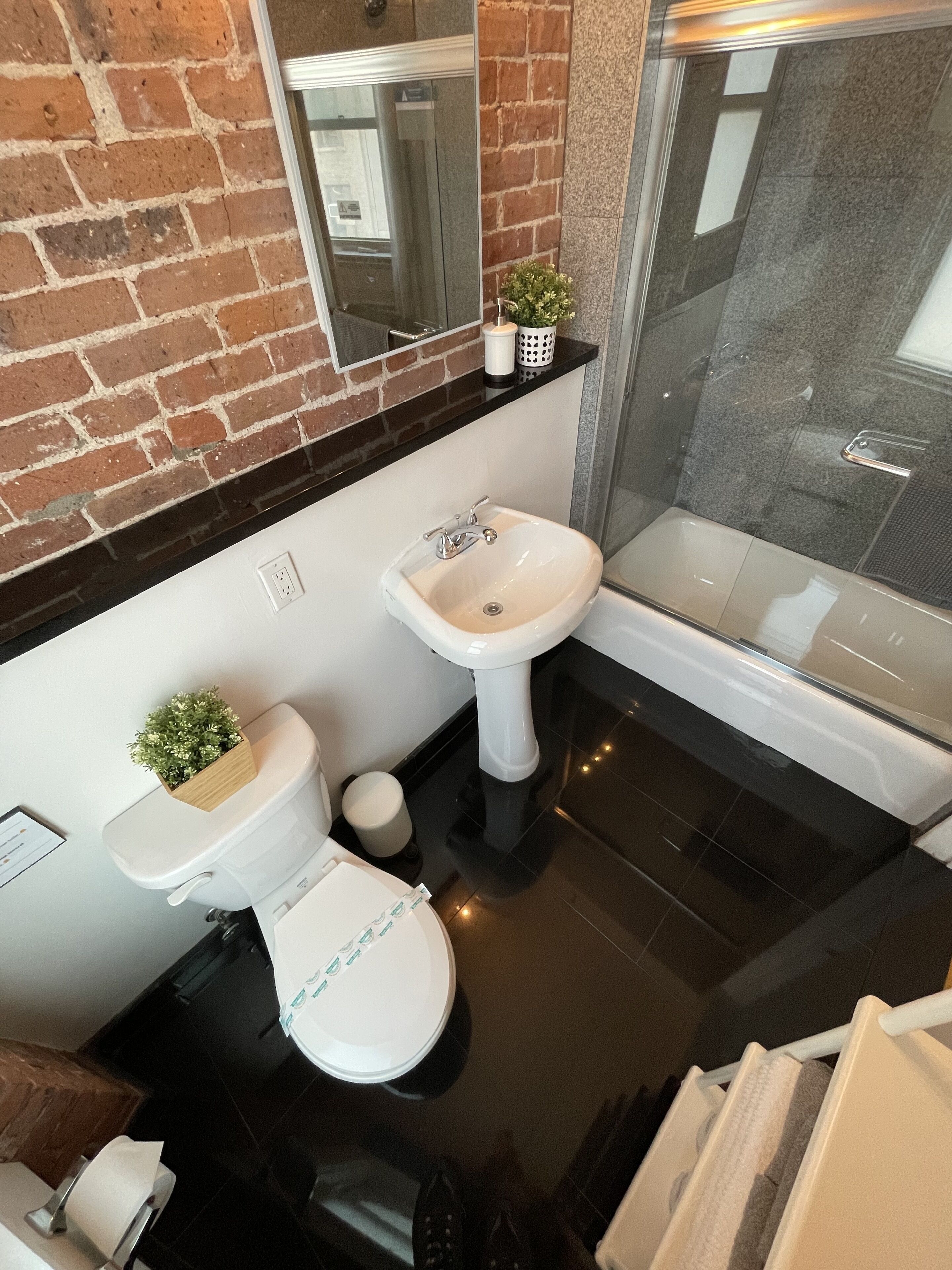 A modern bathroom with a toilet, sink, and bathtub.