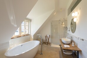 Bathtub, hair dryer, bathrobes, slippers