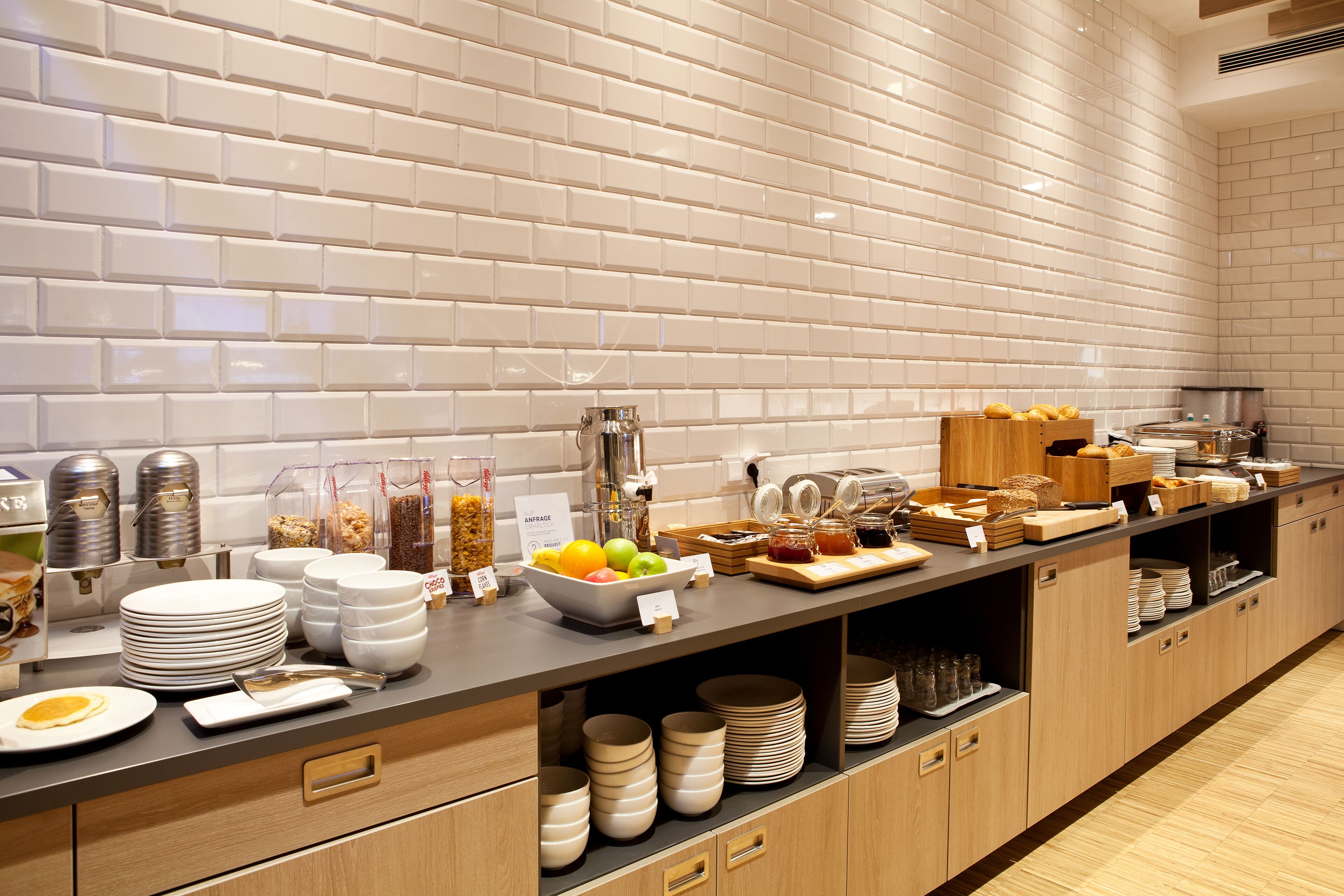 A buffet setup with various food items and utensils.