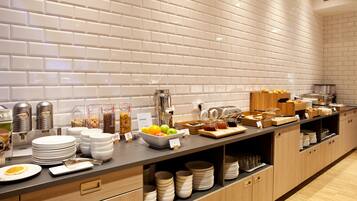 A buffet setup with various food items and utensils.