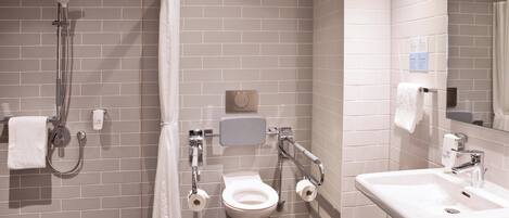 Un baño moderno con ducha, inodoro y lavabo.