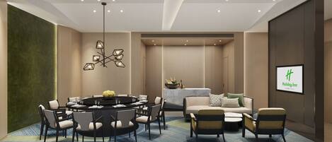 A modern hotel room with a round dining table, comfortable seating, a sofa, and a bed.