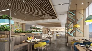A modern restaurant with high ceilings, wooden slats, and a central staircase. - Holiday Inn YONGKANG by IHG (Jinhua)