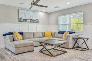 A living room with a sectional sofa, a coffee table, and a side table.