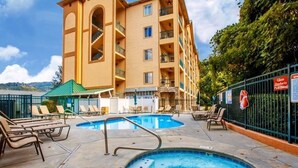 Ein Hotel mit Poolbereich, inklusive Whirlpool und Liegestühlen.