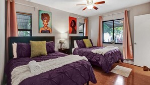 A room with two beds, a ceiling fan, and artwork on the walls. - Heated Pool-Family Villa 7 Min to Beach, BBQ (Deerfield Beach)
