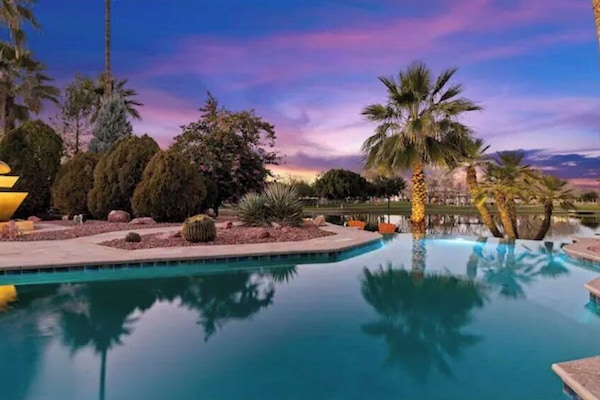 Infinity Edge Heated Pool Facing the Lake and Park alongside Lighted Fountain