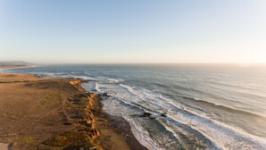 Un paisaje costero con una playa arenosa y un litoral rocoso.