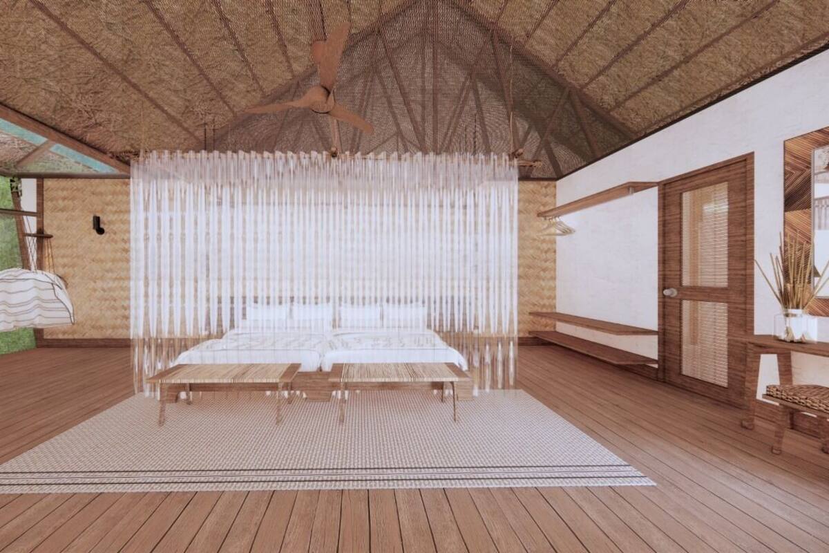 A room with a bed, a wooden floor, a ceiling fan, and a window with a view of greenery.