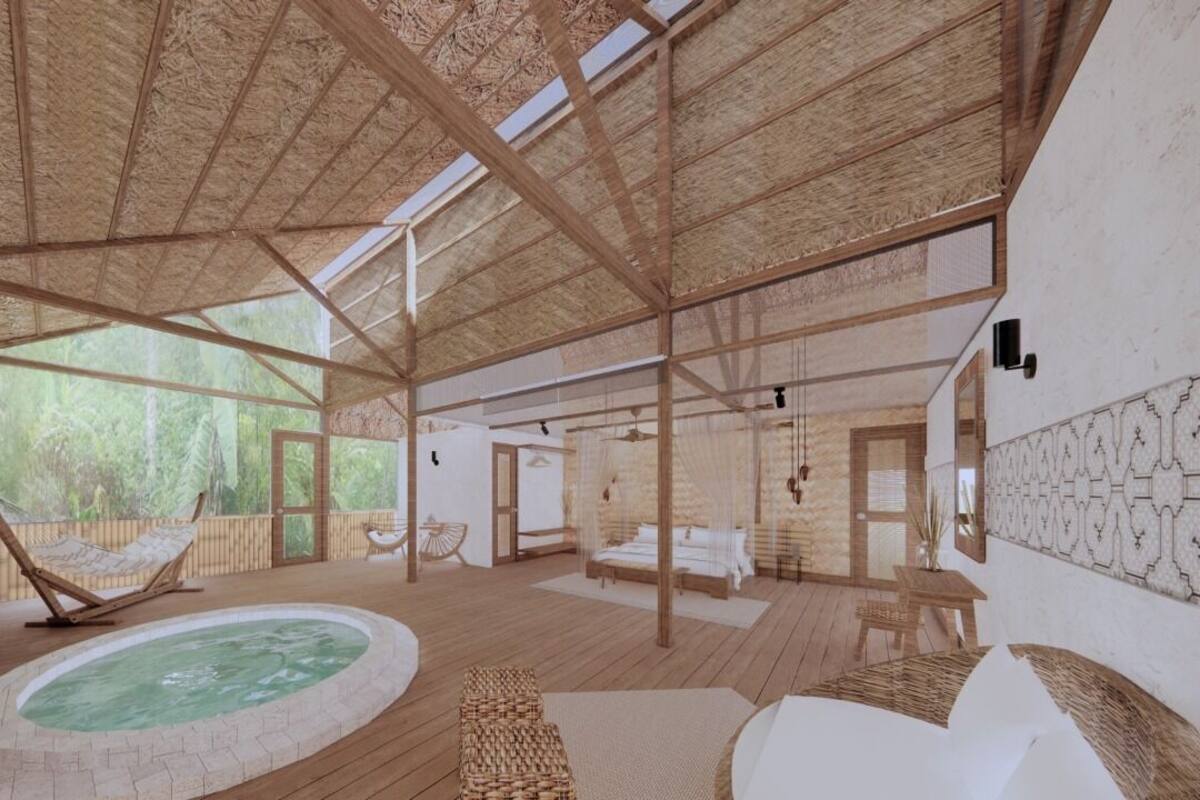 A spacious indoor area with a wooden floor, a hot tub, and a hammock.