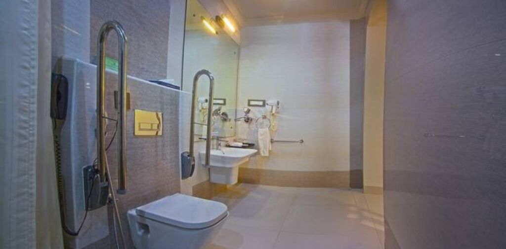 A modern bathroom with a shower, toilet, and sink.