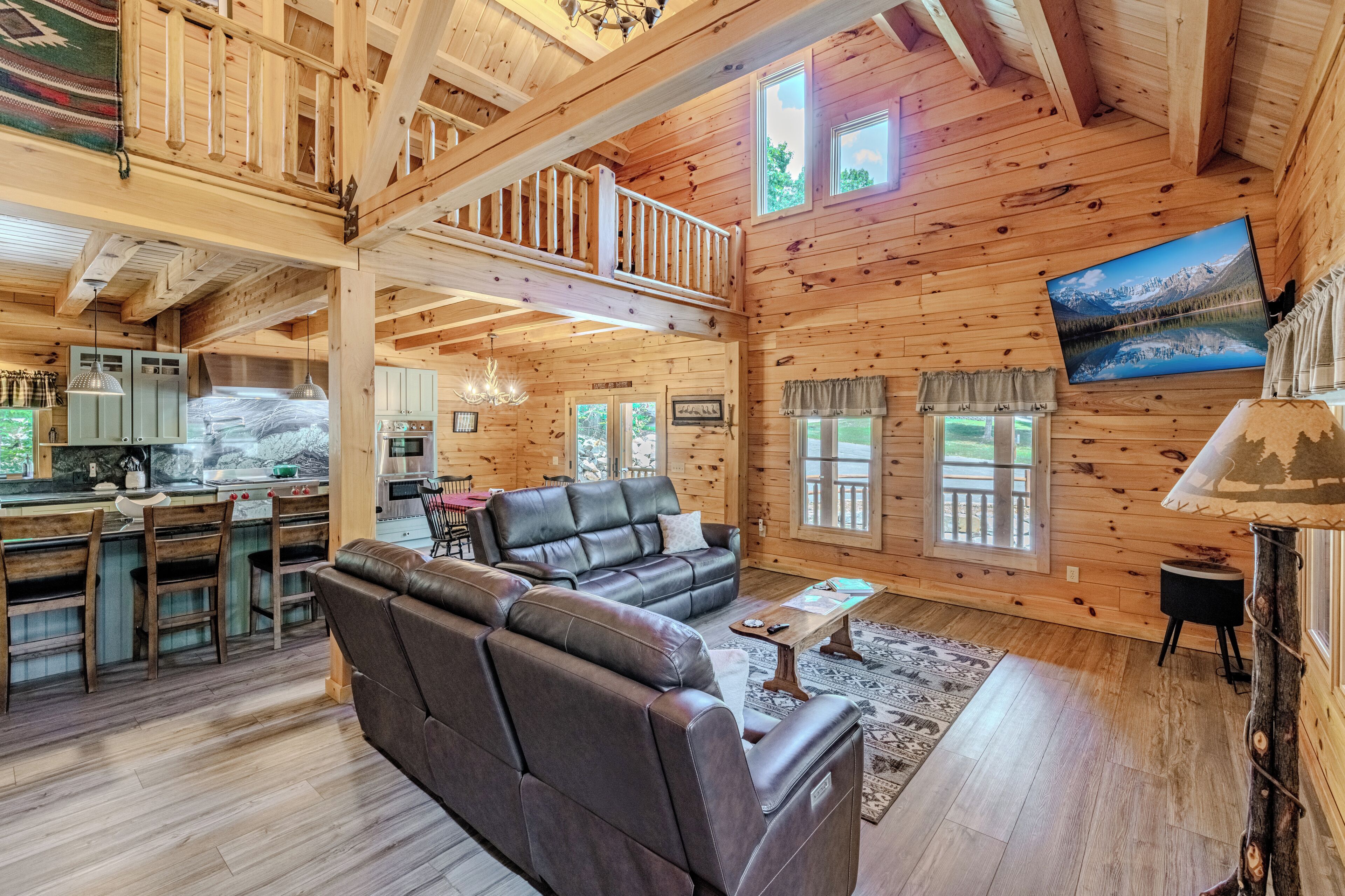 A spacious wooden cabin with a living area, kitchen, and dining space.