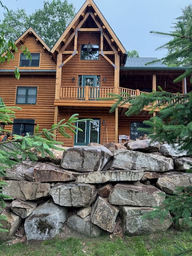 Luxury Log home steps from private beach in Meredith on Lake Winnipesaukee.