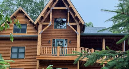 Luxury Log home steps from private beach in Meredith on Lake Winnipesaukee.