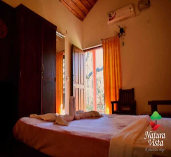 Relax in this serene space with a large bed and a wardrobe for ample storage.