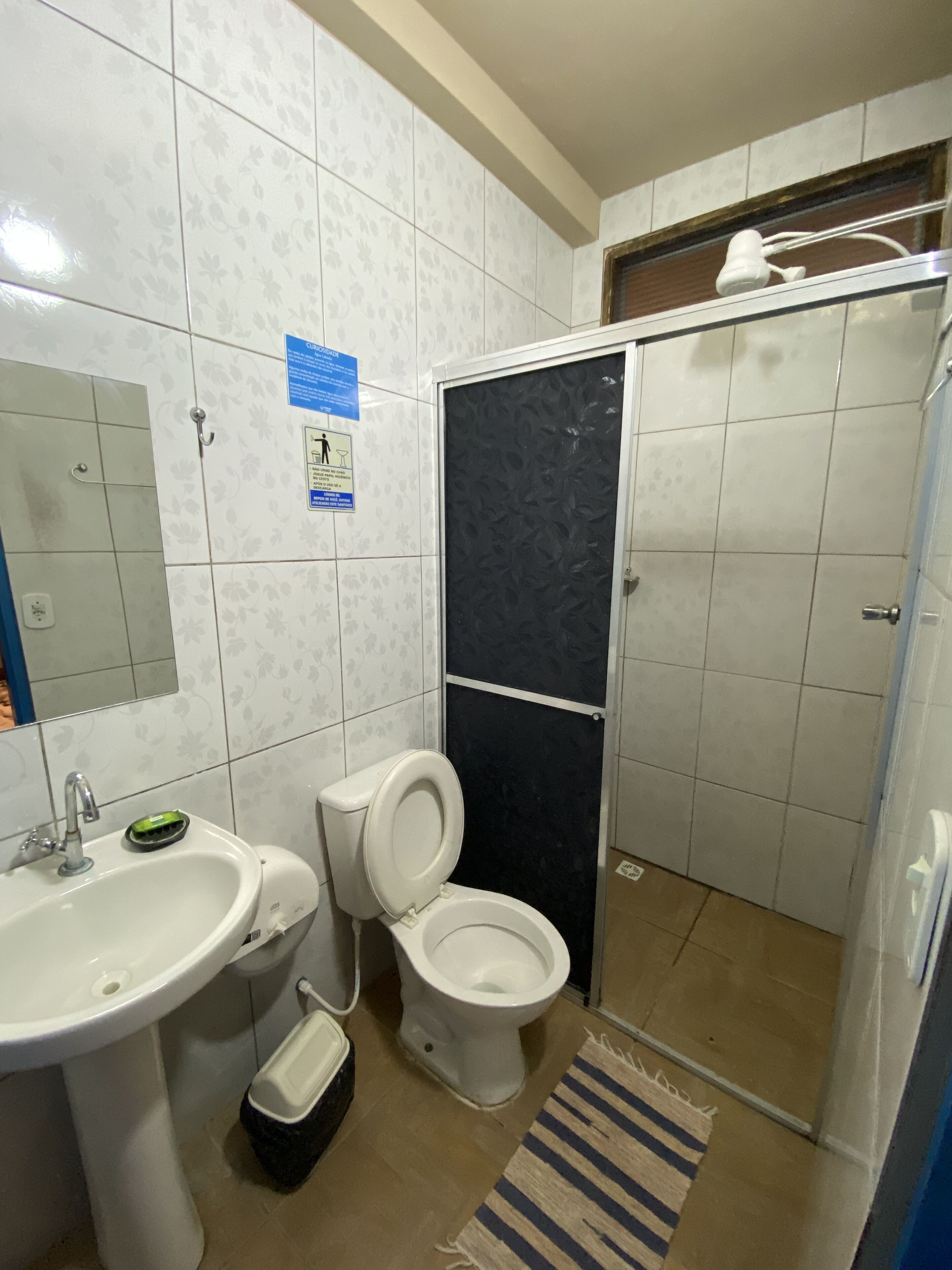 A bathroom with a sink, toilet, and shower.
