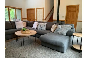 Relax in this inviting living space with a comfortable sectional sofa and round coffee table.