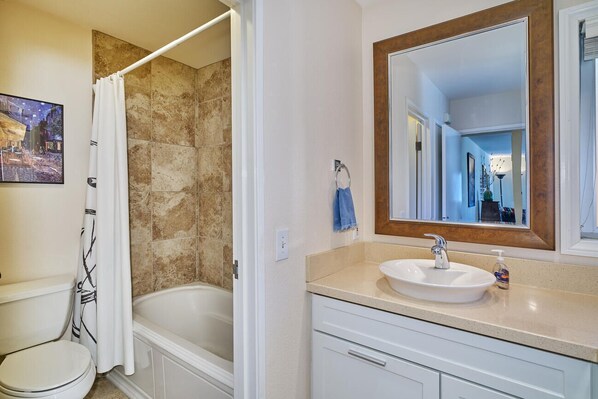Combined shower/bathtub, towels, toilet paper