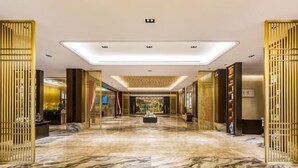A hotel lobby with a marble floor, decorative panels, and a central light fixture. - Hebei Yeshengyuan Hotel (Pingshan)