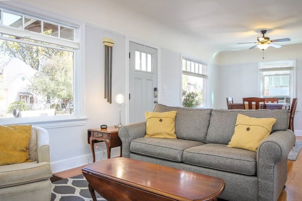 Cozy living and dining rooms with ample natural light. The couch folds into a bed for added sleeping space.