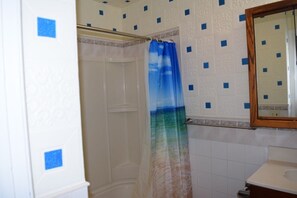 Combined shower/bathtub, towels, soap, toilet paper