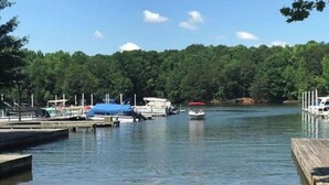 A marina with docked boats and a sandy shore.