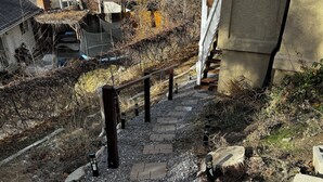 A stone staircase leading up to a building, surrounded by gravel and vegetation. - Lovely 1-Bdrm Apt w/ Hot Tub - 5 mins from Canyons (Cottonwood Heights)